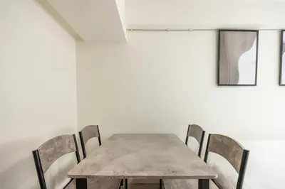 a dining room with a wooden table and chairs at 20 minutes by Haneda Airport train 3-minute walk from Kamata Station Direct access to Tokyo, Yokohama, Ueno in Tokyo