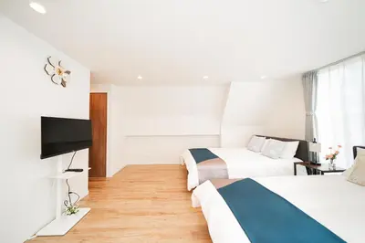 a hotel room with two beds and a flat screen tv at Year-end promotion Shinjuku 401 Great Location 2 mins to S Station New Building Max for 6 people in Tokyo