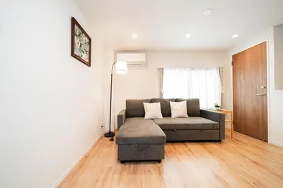 a living room with a couch and a lamp at Year-end promotion Shinjuku 401 Great Location 2 mins to S Station New Building Max for 6 people in Tokyo