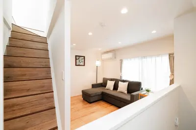 a stairway leading to a living room with a couch at Year-end promotion Shinjuku 401 Great Location 2 mins to S Station New Building Max for 6 people in Tokyo