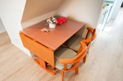 a small table with two chairs and a box of flowers at Year-end promotion Shinjuku 401 Great Location 2 mins to S Station New Building Max for 6 people in Tokyo