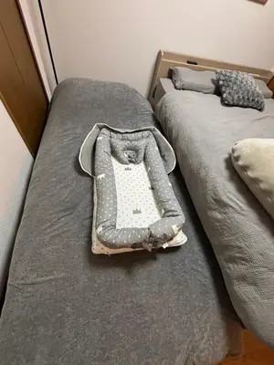 two beds in a bedroom with a tray on them at THE MULTIPLE Shinjuku WEST in Tokyo