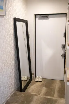 a mirror and a pair of shoes in front of a door at \u963f\u4e45\u6d25\u30cf\u30a4\u30c4201 in Tokyo