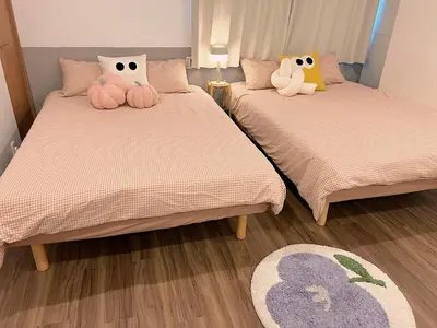 two beds with stuffed animals on them in a room at TOMI Hotel in Tokyo
