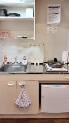 a kitchen with a sink and a counter top at TOMI Hotel in Tokyo