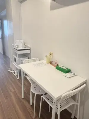 a white table with two chairs in a room at TOMI Hotel in Tokyo