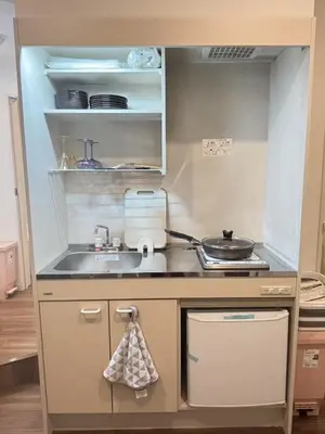 a small kitchen with a sink and a stove at TOMI Hotel in Tokyo