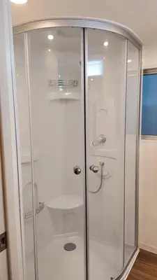 a shower with a glass door in a bathroom at TOMI Hotel in Tokyo