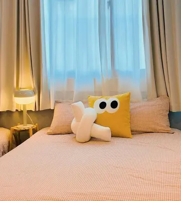 a stuffed animal sitting on top of a bed at TOMI Hotel in Tokyo