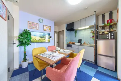 a kitchen with a table and chairs in a room at Shamrock Aoto 303 Cozy Tokyo Stay Near Station Airport Disney Access in Tokyo