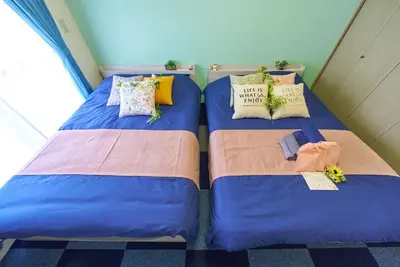 two beds sitting next to each other in a room at Shamrock Aoto 303 Cozy Tokyo Stay Near Station Airport Disney Access in Tokyo