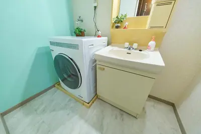 a washing machine and a sink in a bathroom at Shamrock Aoto 303 Cozy Tokyo Stay Near Station Airport Disney Access in Tokyo