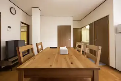 a dining room with a wooden table and chairs at \u5713\u798f\u30d3\u30eb in Tokyo