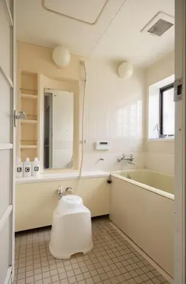 a bathroom with a tub and a toilet in it at \u5713\u798f\u30d3\u30eb in Tokyo