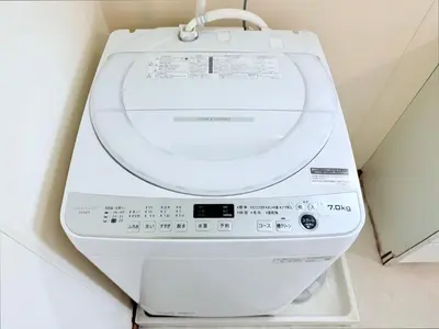 a white washing machine sitting in a room at Terrace Stay Omori in Tokyo