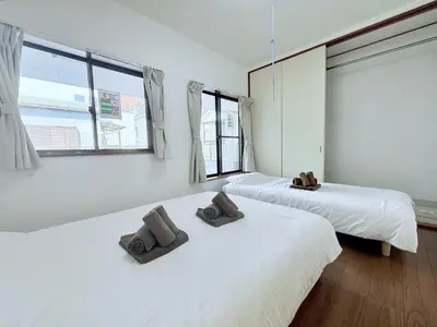 two beds in a room with two towels on them at Terrace Stay Omori in Tokyo