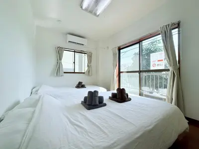 a bedroom with two beds with brown slippers on them at Terrace Stay Omori in Tokyo
