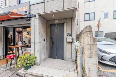 a building with a car parked outside of it at Vista Stay Oshiage in Tokyo
