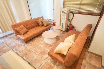 a living room with a brown couch and a table at Jazz Building 4F5F - Vacation STAY 28953v in Tokyo
