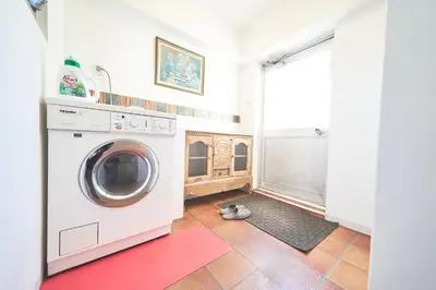a washing machine in a laundry room with a red rug at Jazz Building 4F5F - Vacation STAY 28953v in Tokyo