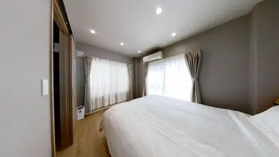a bedroom with a white bed and a window at Hotel Yado SK Shinkoiwa - Vacation STAY 17432v in Tokyo