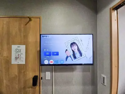 a flat screen tv hanging on a wall at Hotel Yado SK Shinkoiwa - Vacation STAY 17432v in Tokyo