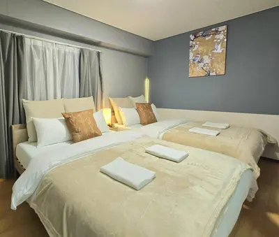 two beds sitting next to each other in a room at New! Quiet Akasaka Stay Near Roppongi max 8 guests in Tokyo