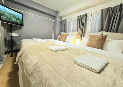a bedroom with a large bed with two towels on it at New! Quiet Akasaka Stay Near Roppongi max 8 guests in Tokyo