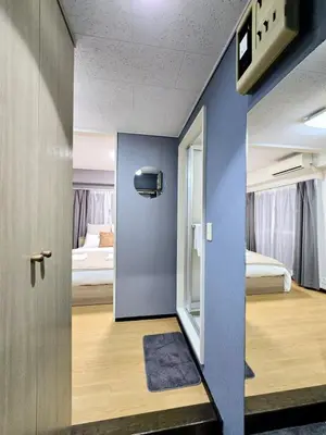 a room with a blue wall and a bedroom at New! Quiet Akasaka Stay Near Roppongi max 8 guests in Tokyo