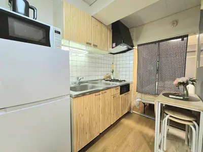 a kitchen with a white refrigerator and a sink at New! Quiet Akasaka Stay Near Roppongi max 8 guests in Tokyo