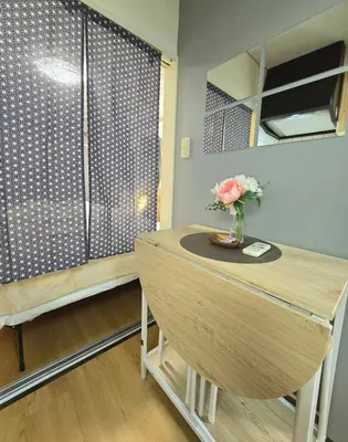 a room with a table with a vase of flowers on it at New! Quiet Akasaka Stay Near Roppongi max 8 guests in Tokyo