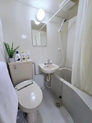 a white bathroom with a toilet and a sink at New! Quiet Akasaka Stay Near Roppongi max 8 guests in Tokyo