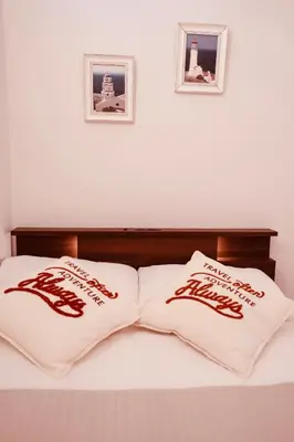 two pillows on a bed with two pictures on the wall at \u6c60\u888b\u7ad9\u6b65\u884c3\u5206\u949f \u56e2\u4f536-10\u4eba\u5165\u4f4f in Tokyo