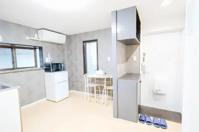 a small kitchen with a refrigerator and a table at Shinjuku 2bed rooms apartment#2室1厅#智能马桶#高速无限制网路1 in Tokyo