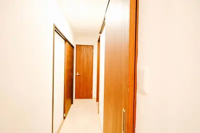 a hallway with wooden doors and a mirror at Shinjuku 4bed rooms apartment#4室2厅2浴室2卫生间#智能马桶#高速无限制网路3&1 in Tokyo