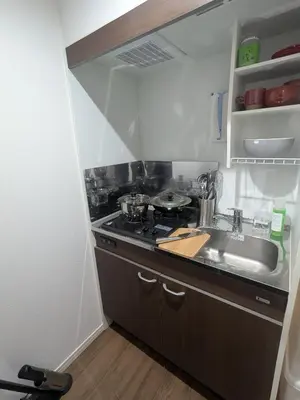 a small kitchen with a sink and a stove at 15min from Haneda Airport Cozy for 3 in Tokyo