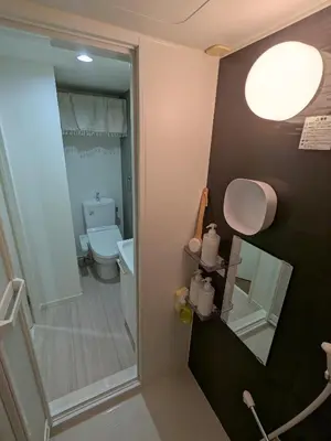 a small bathroom with a toilet and a mirror at 15min from Haneda Airport Cozy for 3 in Tokyo