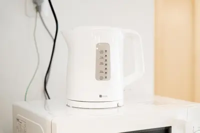 a white blender sitting on top of a microwave at Waseda Star New Open Station 2 Minutes in Tokyo