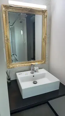 a bathroom with a white sink and a mirror at \u82b1\u306e\u91cc in Tokyo
