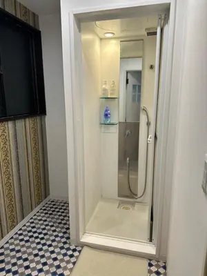 a shower with a glass door in a bathroom at \u82b1\u306e\u91cc in Tokyo