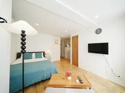 a bedroom with a bed and a tv on a wall at OpenSale Shinjuku 301 New Building 2mins to Waseda Station Max for 3 people in Tokyo