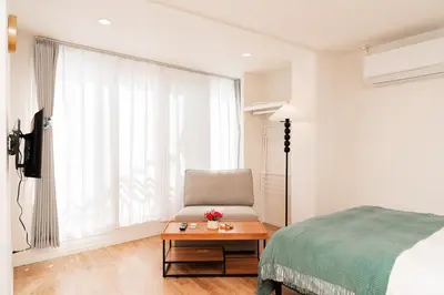 a bedroom with a bed and a chair and a table at OpenSale Shinjuku 301 New Building 2mins to Waseda Station Max for 3 people in Tokyo