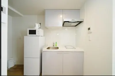 a white kitchen with a sink and a microwave at OpenSale Shinjuku 301 New Building 2mins to Waseda Station Max for 3 people in Tokyo