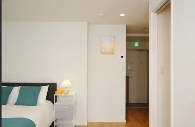a bedroom with a bed and a door to a hallway at OpenSale Shinjuku 301 New Building 2mins to Waseda Station Max for 3 people in Tokyo