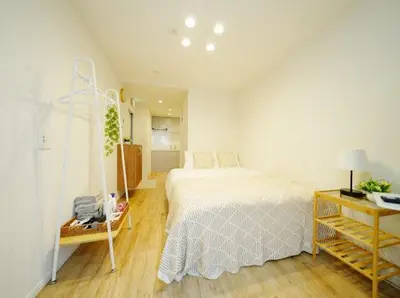 a bedroom with a white bed and a table and a room at OpenSale Shinjuku 302 New Build 2mins to Waseda Station Max for 2 people in Tokyo