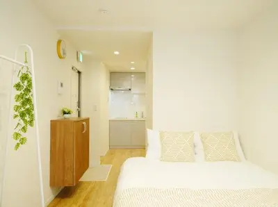 a white bedroom with a bed and a kitchen at OpenSale Shinjuku 302 New Build 2mins to Waseda Station Max for 2 people in Tokyo