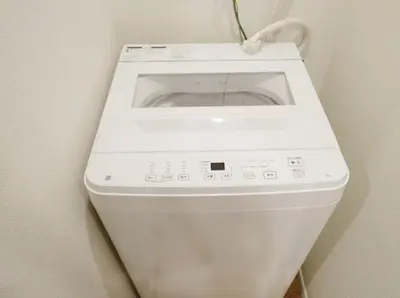 a white washing machine in a corner of a wall at OpenSale Shinjuku 302 New Build 2mins to Waseda Station Max for 2 people in Tokyo