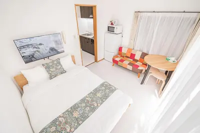 a small room with a bed and a table at Shinjuku Terrace 226 BnB in Tokyo