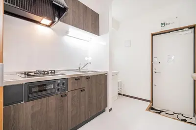 a kitchen with wooden cabinets and a refrigerator at Shinjuku Terrace 226 BnB in Tokyo