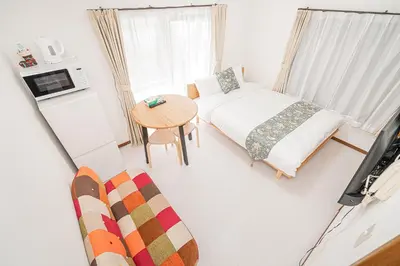 a small room with a bed and a table at Shinjuku Terrace 226 BnB in Tokyo